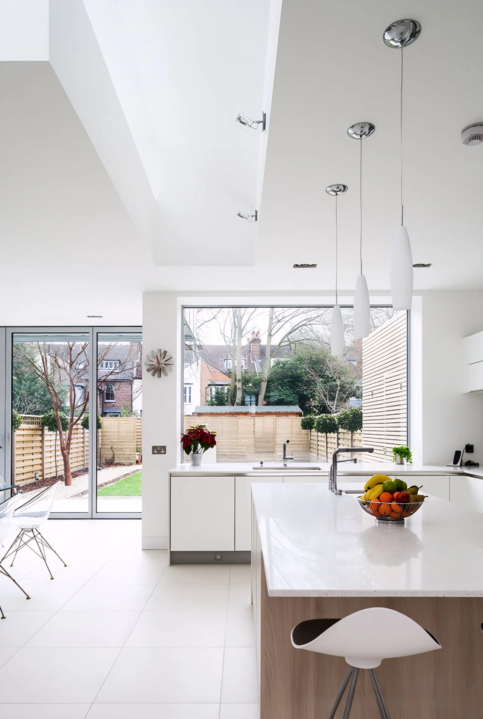 New white kitchen with island beneath a rooflight