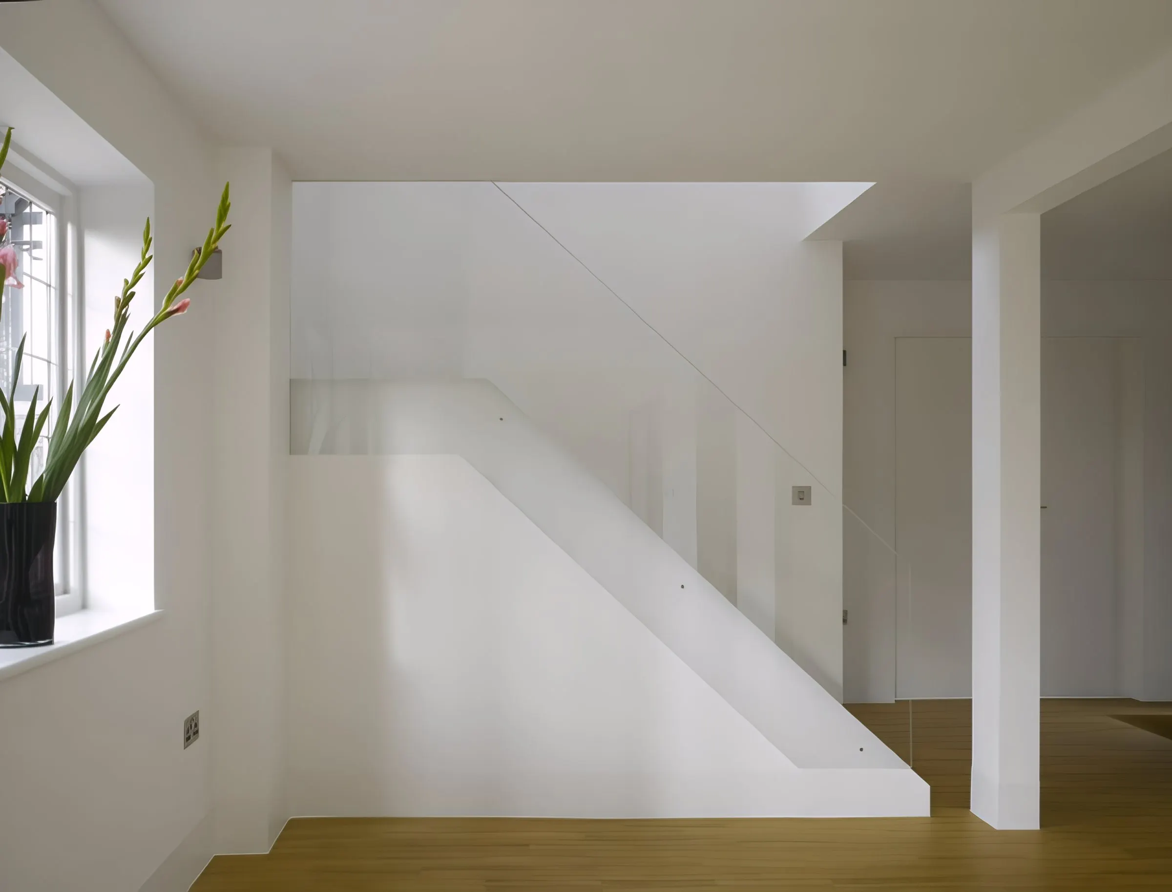Hallway and staircase with glass balustrade