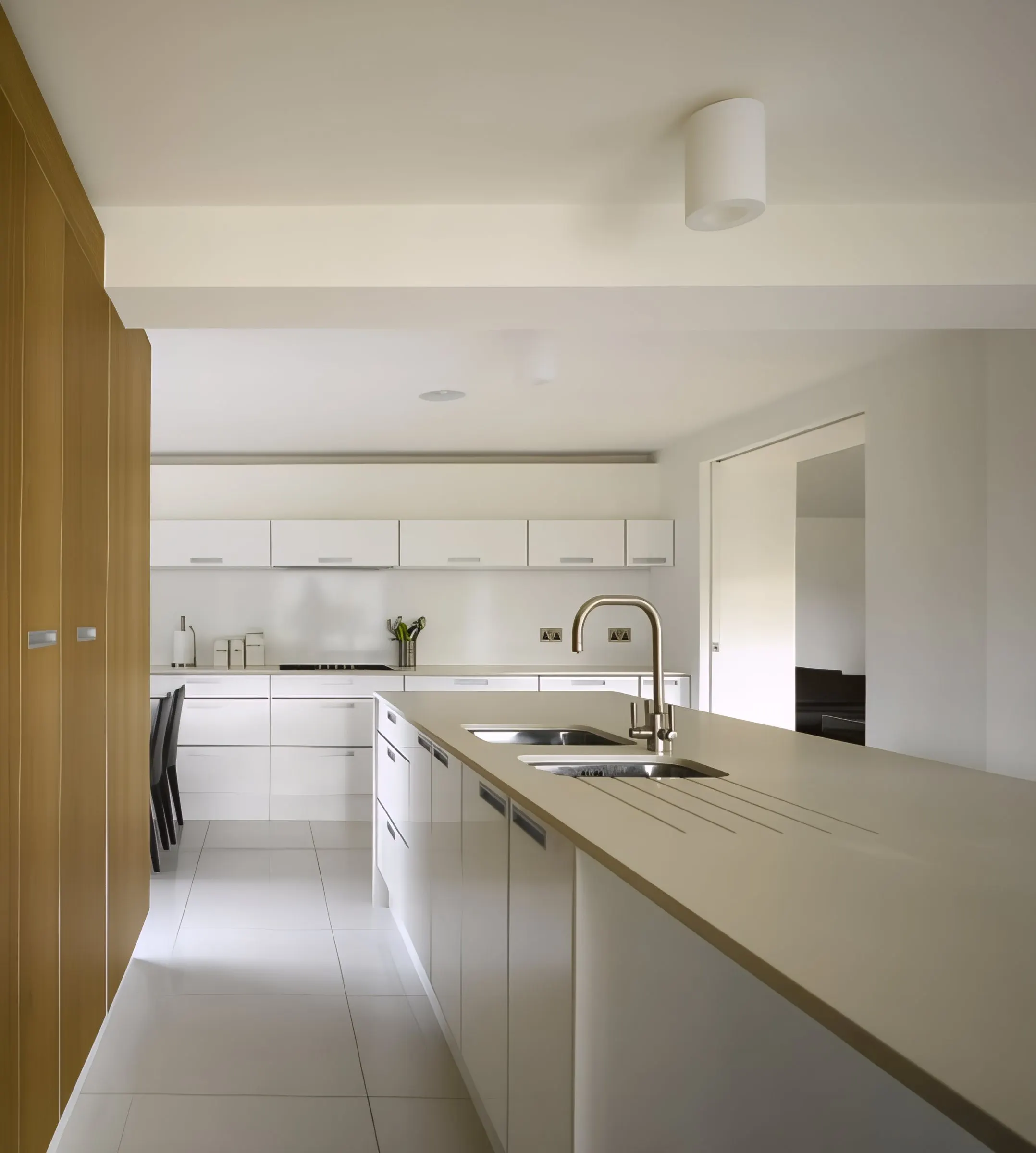 Kitchen with long island and view to the rear garden