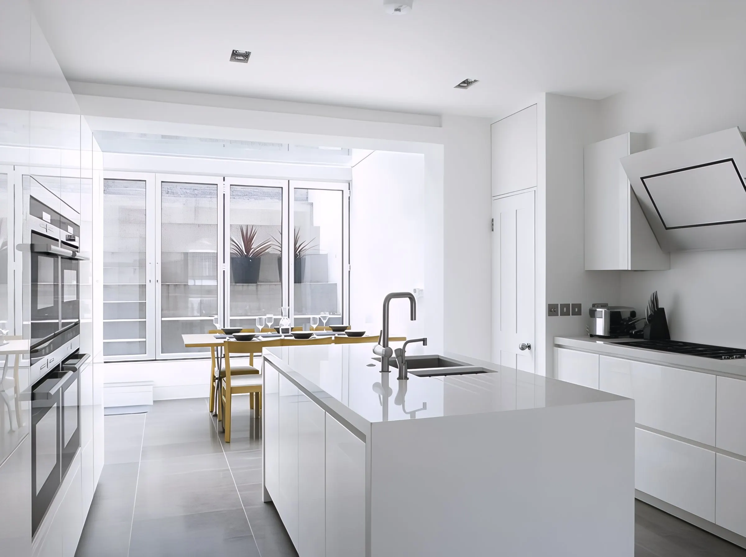White kitchen with island and glazed rear wall