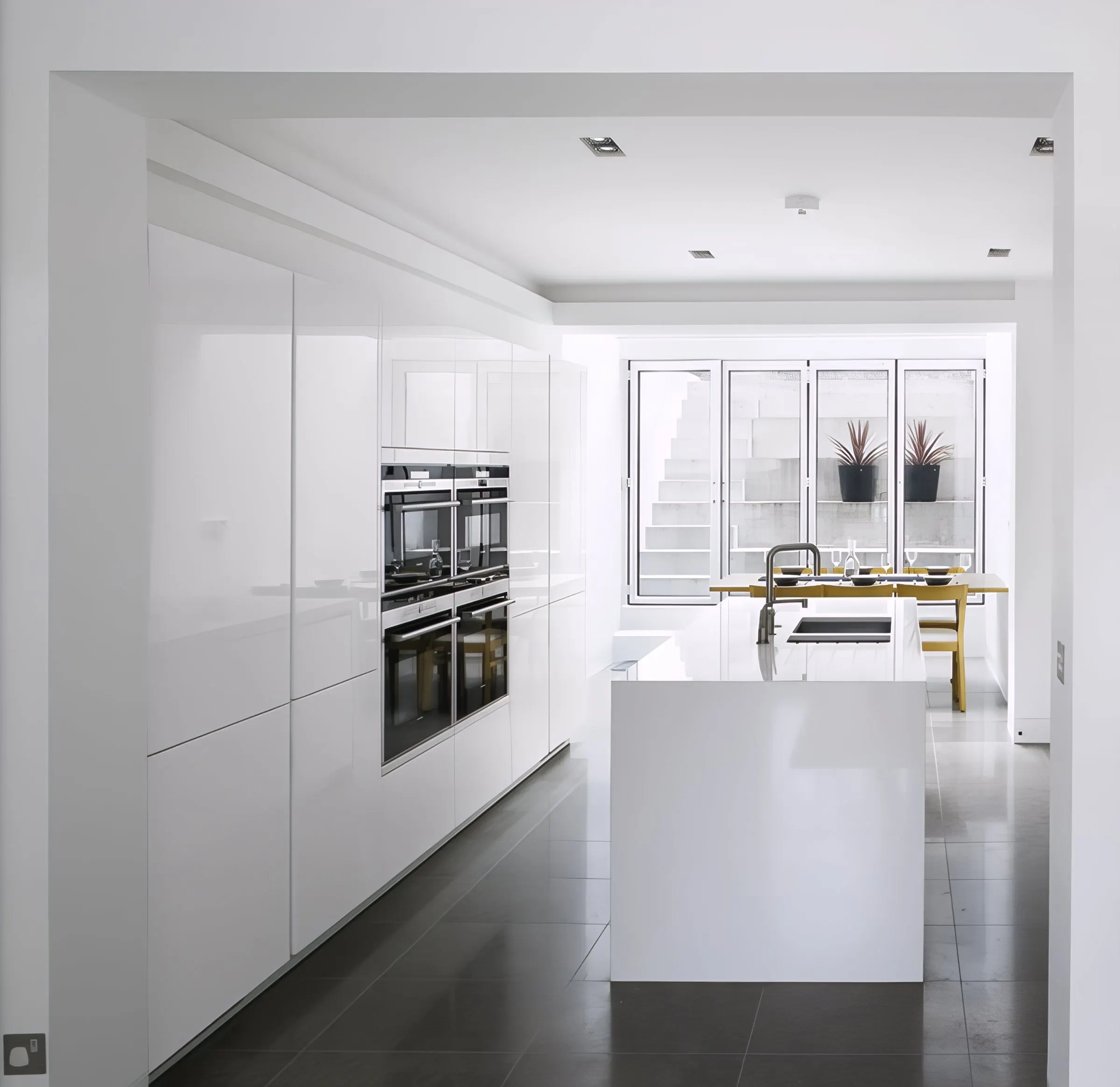Full-height white cabinetry and island