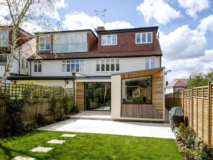Completed rear extension at Lyndale with cedar-clad window box and sliding doors to the garden
