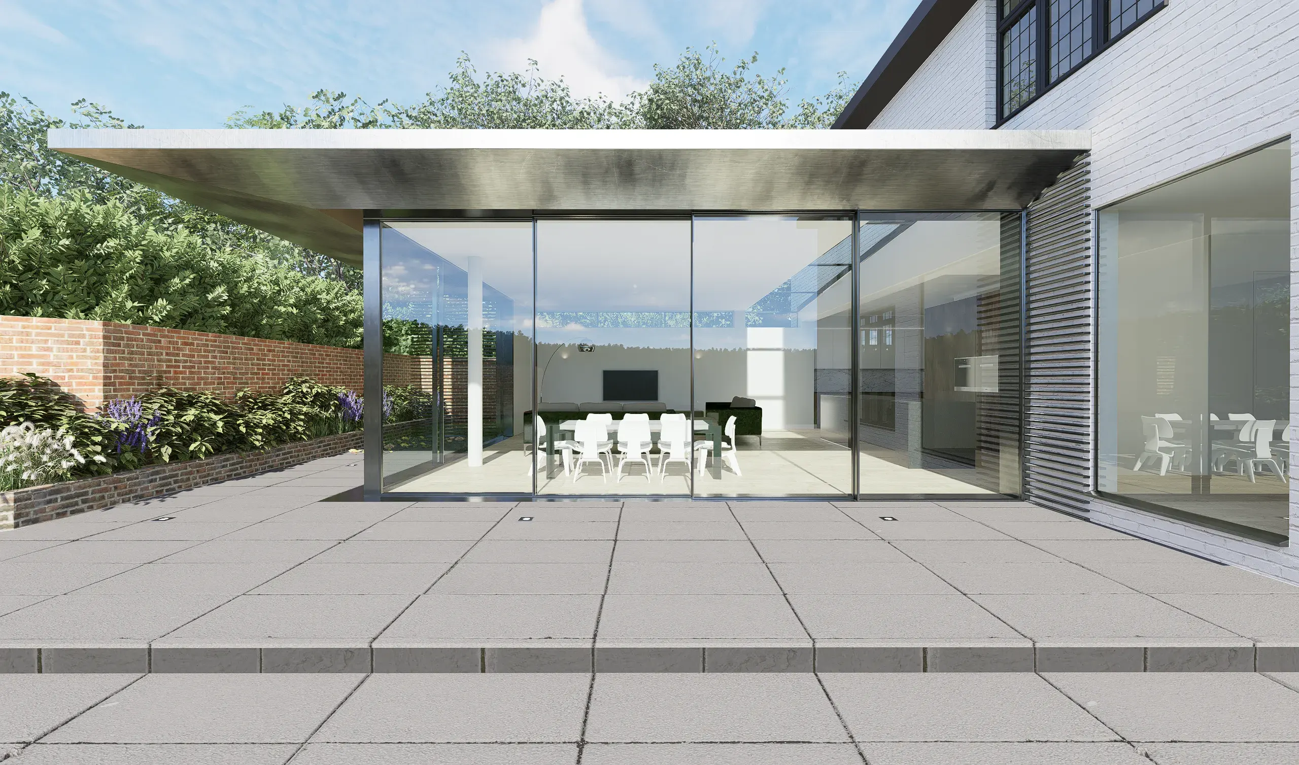 The glazed extension seen across a stone terrace