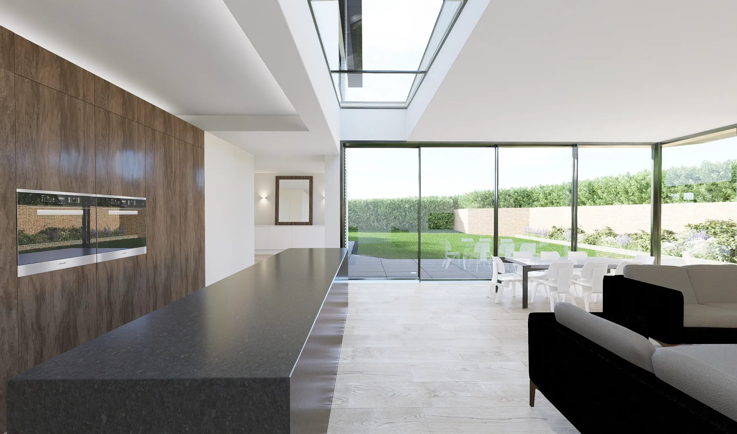 Kitchen island beneath a long rooflight, with sliding doors to the garden